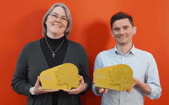 Jo Fison and Matt Jenkins holding their Golden National Pearson's Awards
