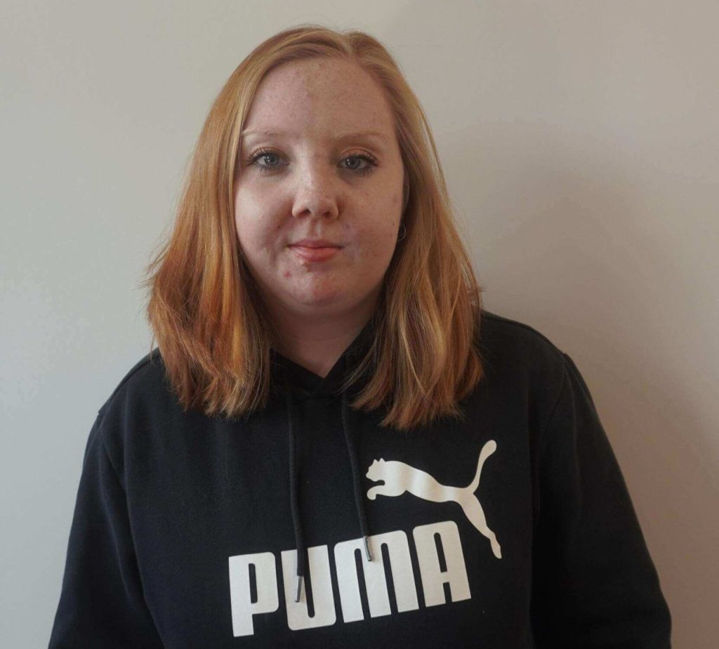 Jayleigh stood proudly in her black jumper smiling.