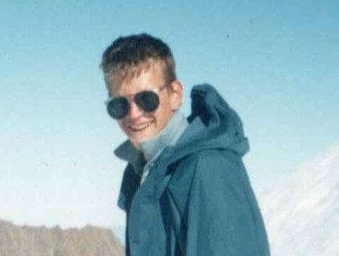 Photo of Paul Mclaren in his winter gear and sunglasses on a snowy mountain