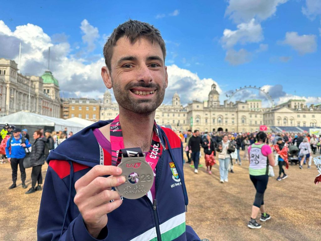 Hugh Allum-Pearce with his London Marathon medal